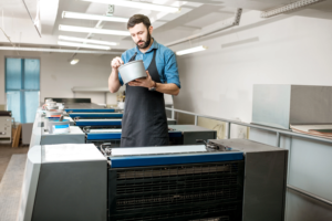 printing-industry-worker-holding-container-in-fact-2026-09-22-02-57-11-utc
